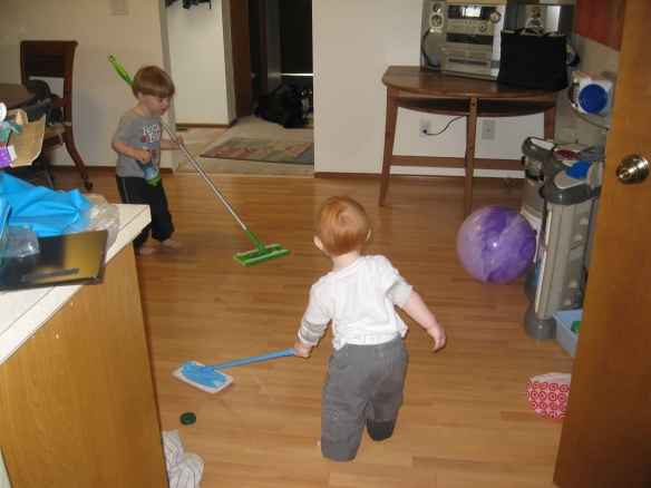 Zack mans the full size swiffer while Josh has the kid sized version. As an added bonus, they may accidentally get the floor clean too!